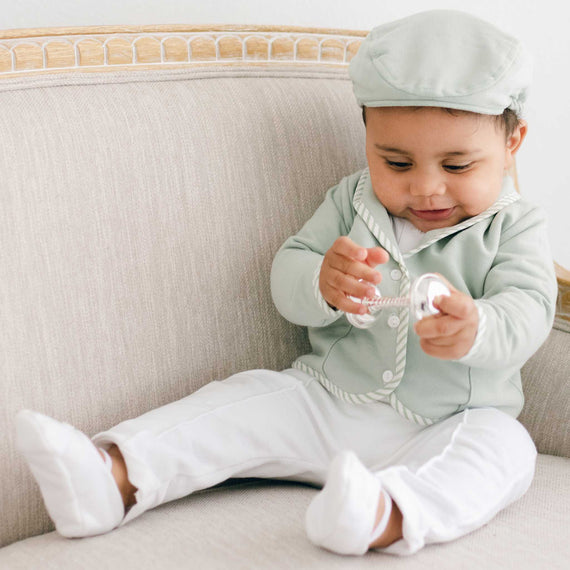 Baby boy wearing the green Theodore 3-Piece Suit, including the jacket, pants, and onesie.