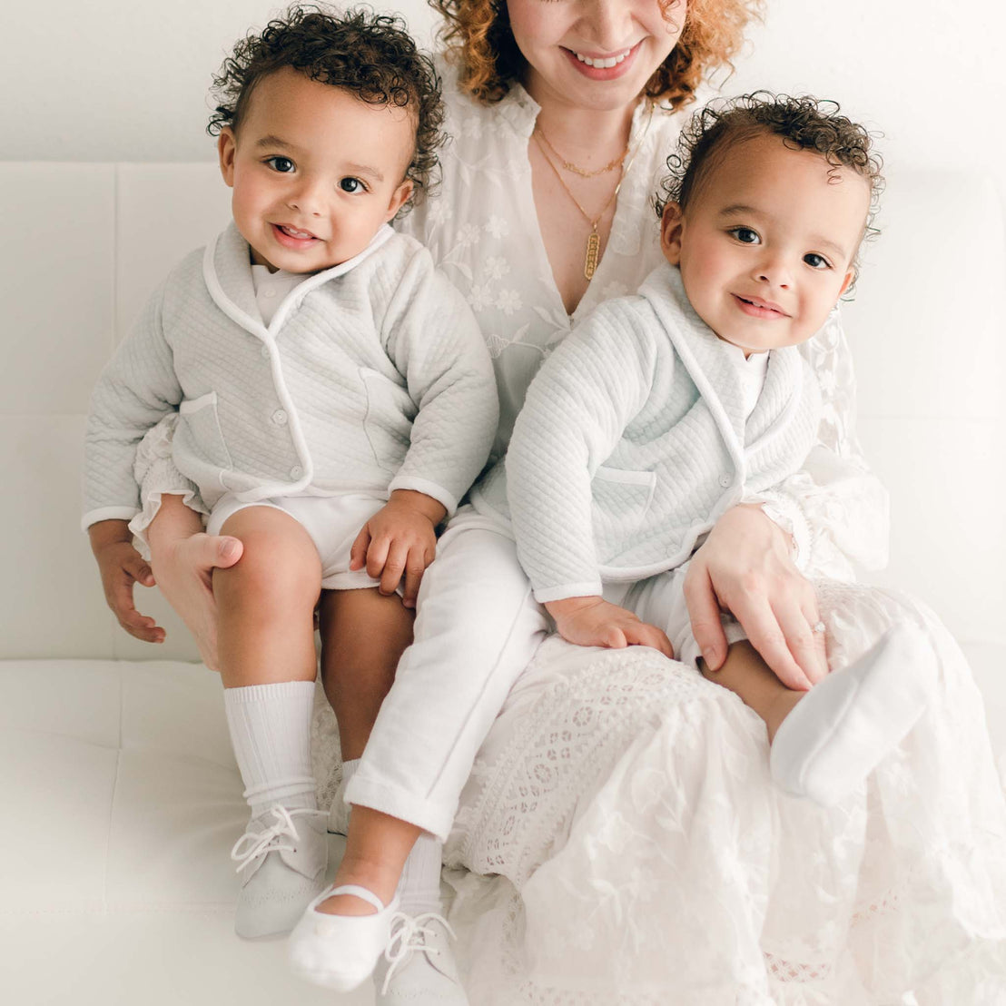 Two twin baby boys with their mother. They are wearing the Asher 3-Piece Suit, one in grey and the other in powder blue. 