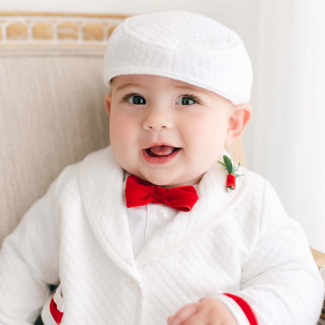 A cheerful baby dressed in a Noah 3-Piece Suit with Red Trim, smiling brightly at the camera.