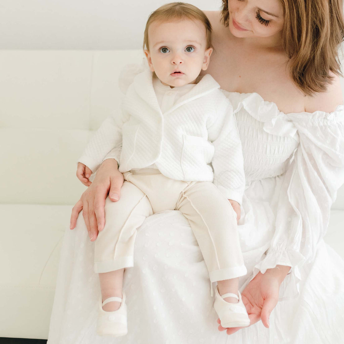 Baby boy sitting on his mother's lap. He is wearing the Braden 3-Piece Suit