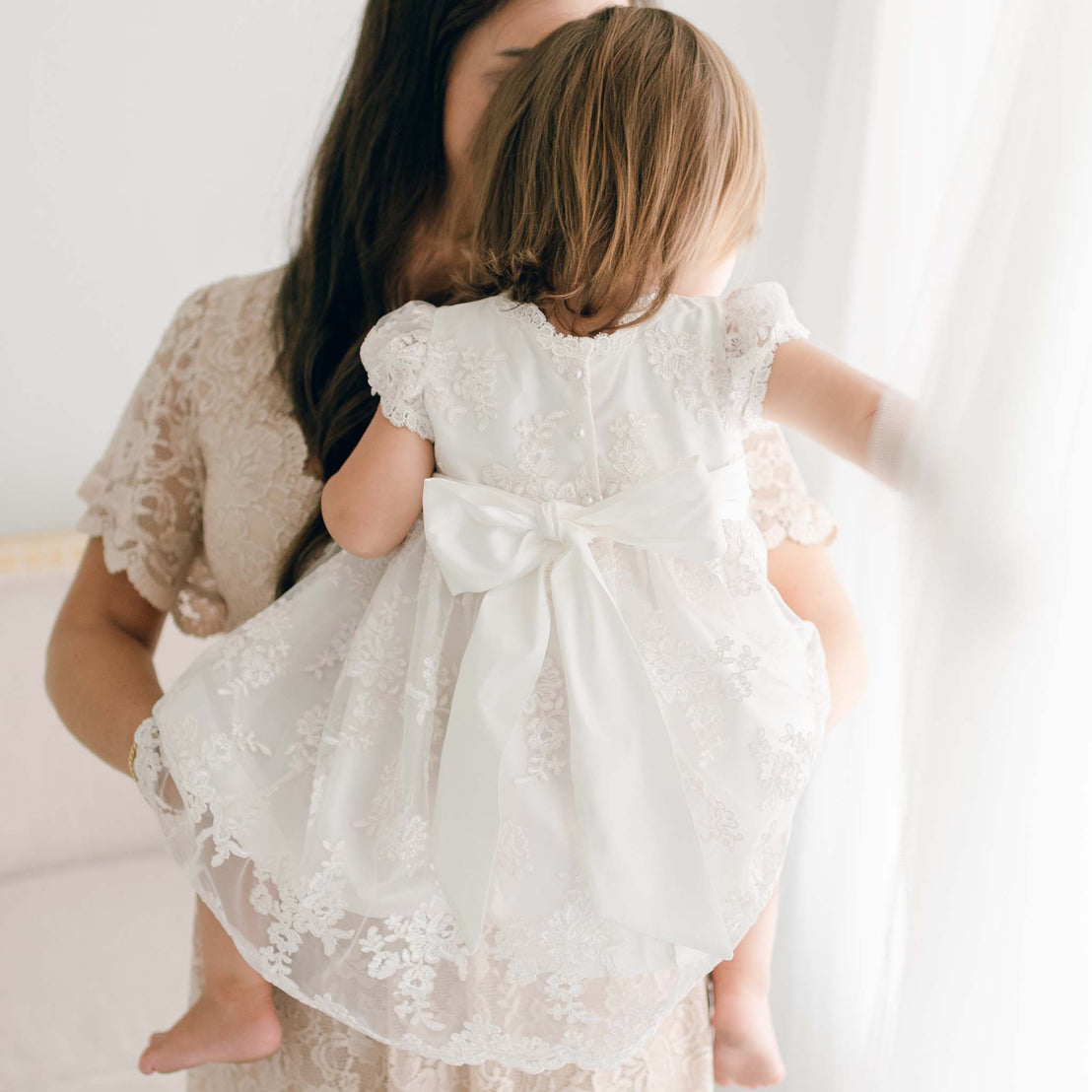 Back of the Penelope christening dress with large bow detail.