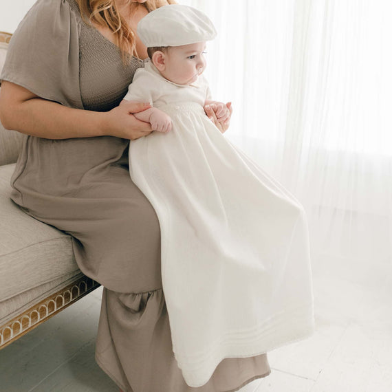 Baby boy wearing the convertible baptism gown and Romper Skirt Set. The skirt attaches to the Oliver Romper to turn the romper into a traditional christening gown.