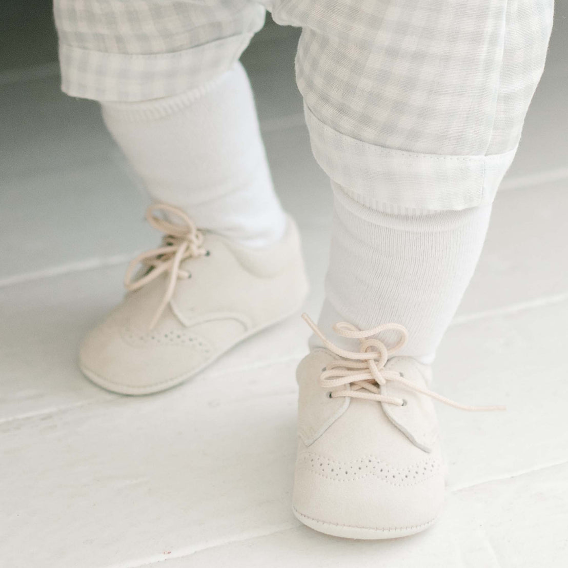 Baby boy wearing the Boys White Knee Socks made from cotton/nylon and spandex.