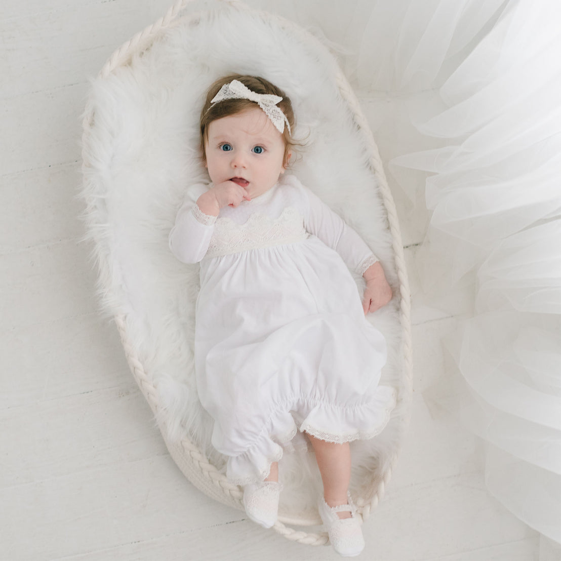 Hailey layette laying in basket