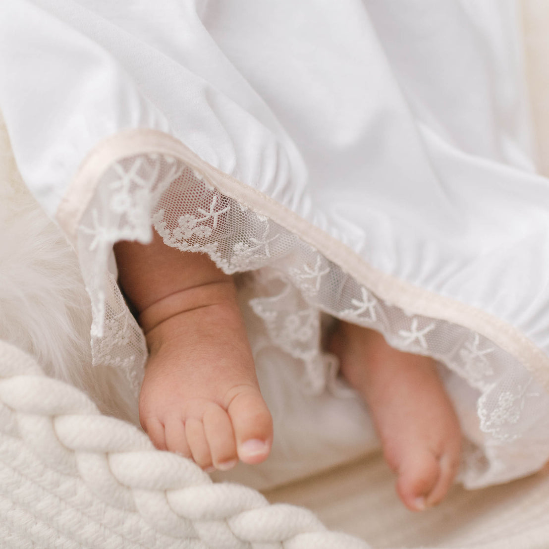 Close up photo showing the Tessa Quilt Newborn Gown skirt hem.