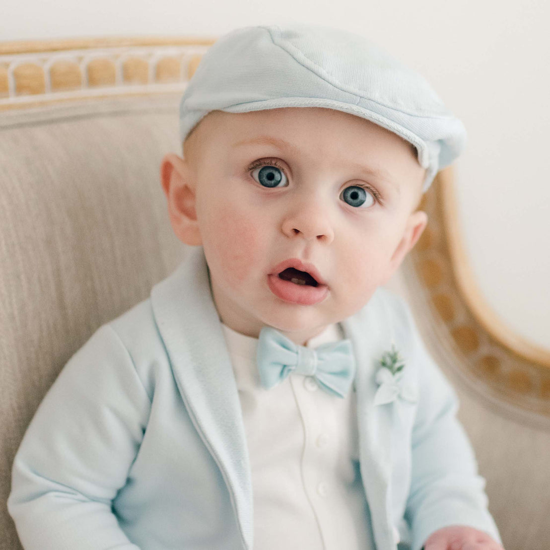 Close up of robin's egg newsboy cap and velvet bow tie