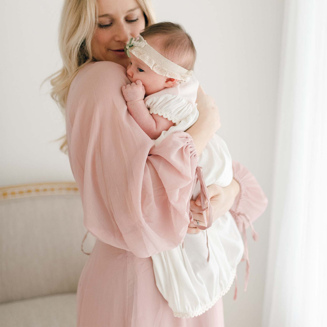 Mom hugging baby girl in Natalie layette