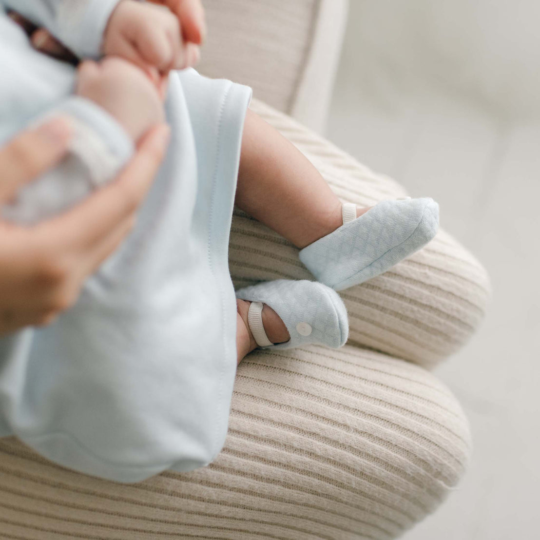 Blue newborn baby booties showing size and texture of cotton