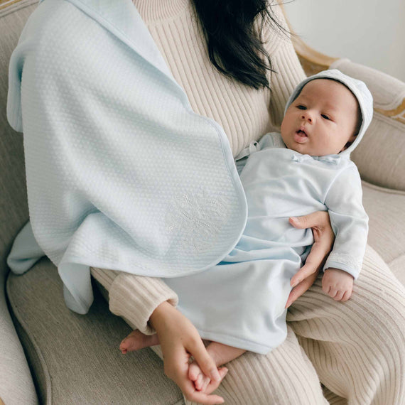 Baby boy and mom with blue cotton personalized blanket and newborn gown