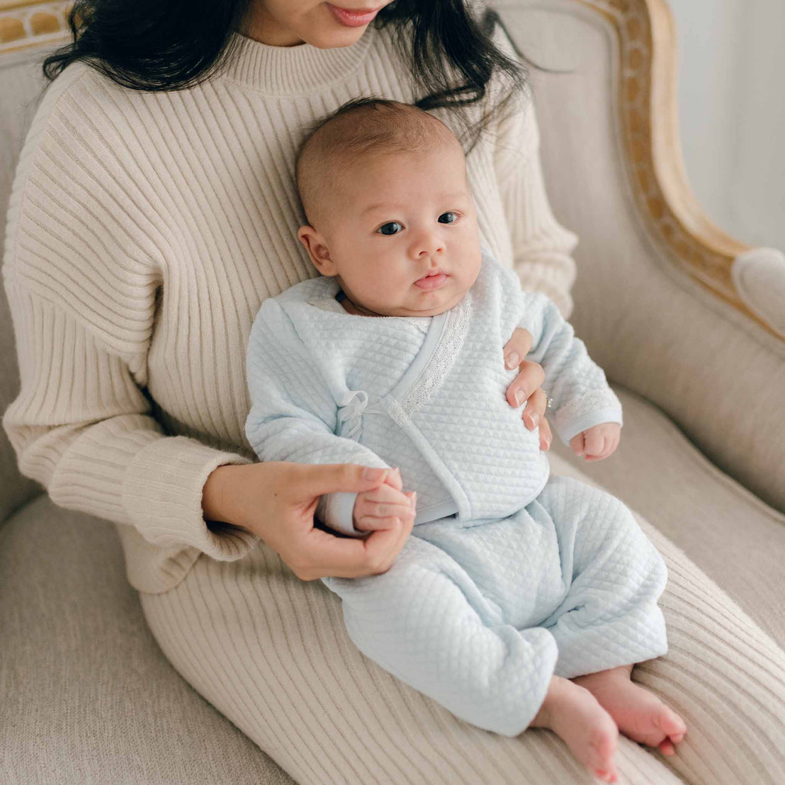 Baby boy on Mom's lap in blue newborn top and pants outfit