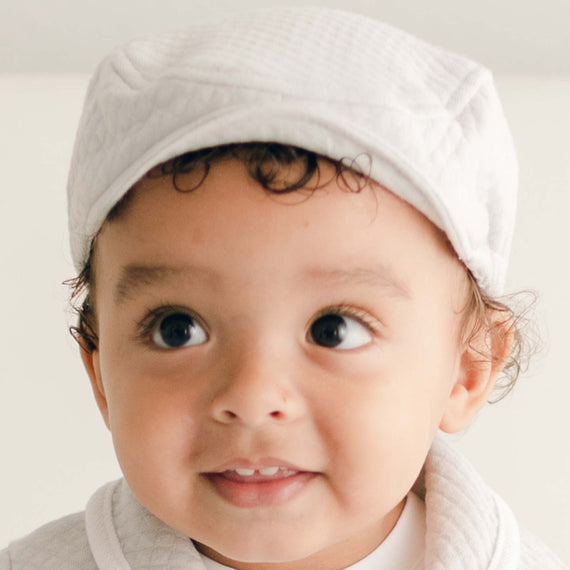 Baby boy wearing the grey Asher Quilted Newsboy Cap made from 100% Quilted Cotton with a soft elastic back.