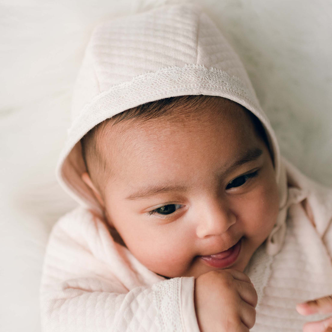 Baby girl wearing pink cotton bonnet