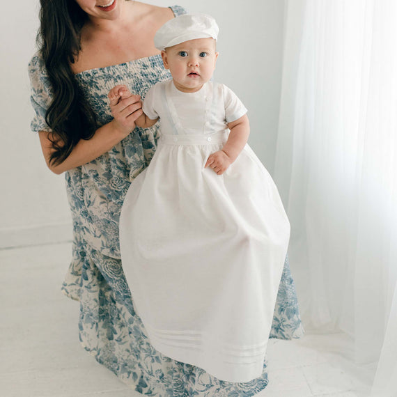 Baby boy sitting on his mother's lap. He is wearing the Owen Convertible Romper and Skirt Set.