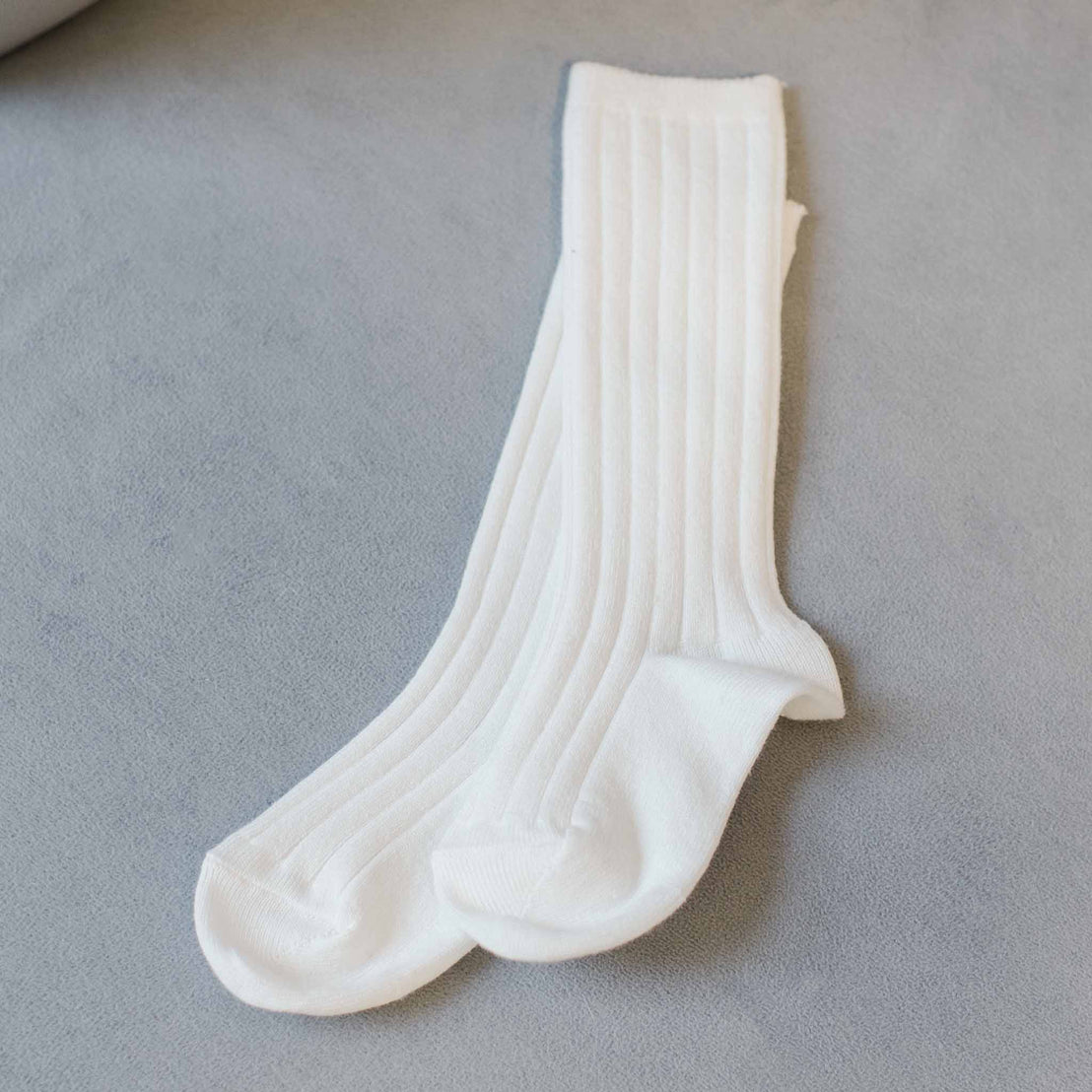 Flat lay photo of the knee-length Cream Ribbed Socks 