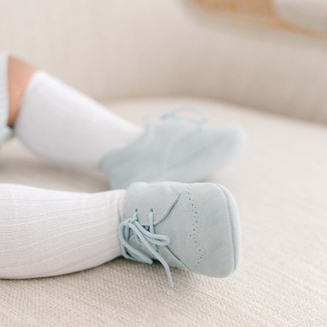 Baby boy wearing the Theodore Suede Shoes in blue.