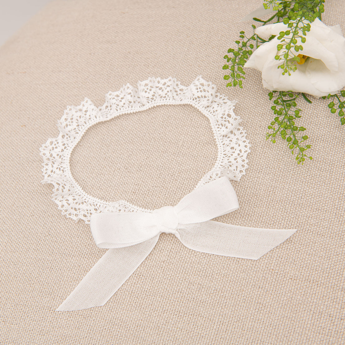 Flatlay photo of Poppy baby headband made of lace 