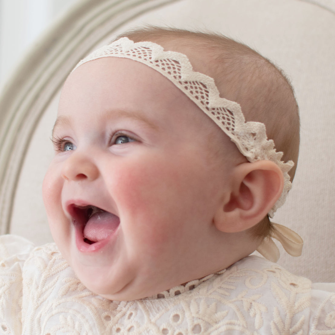 Baby laughing and wearing the Ingrid Headband