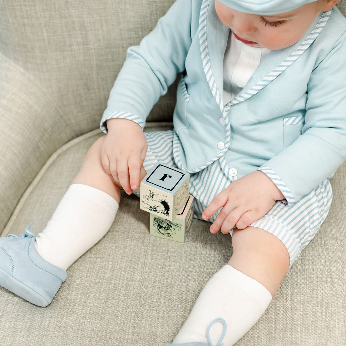 Baby boy wearing the Boys White Knee Socks made from cotton/nylon and spandex.