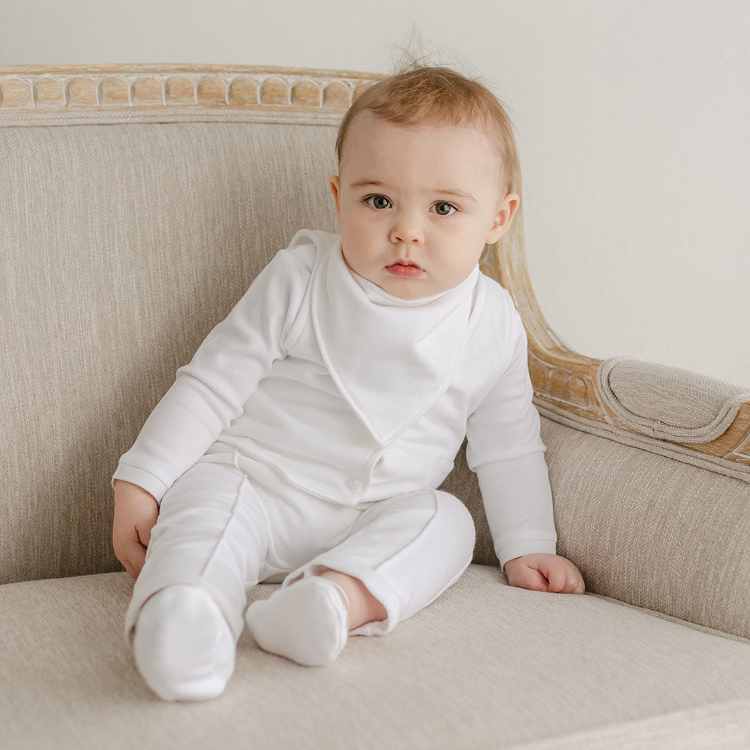 Photo of a baby boy wearing the Miles Bandana Bib made from white french terry cotton