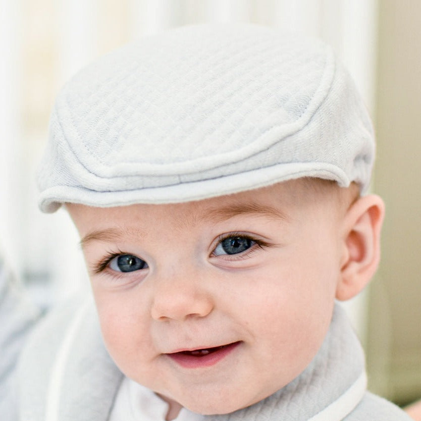 Cute baby boy wearing the Asher quilted newsboy cap.