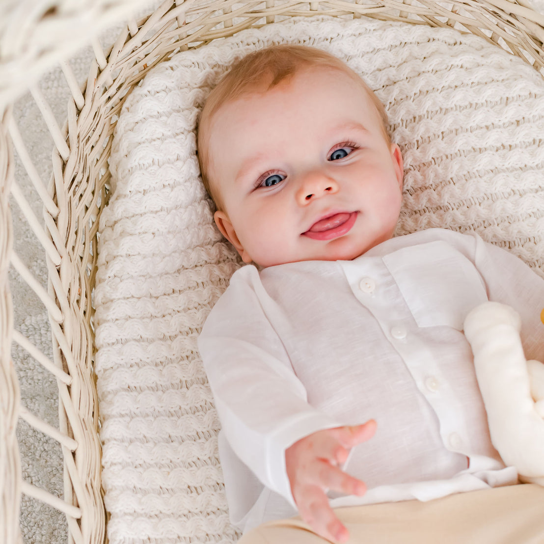 Smiling baby boy in a crib wearing the Silas White Linen Shirt