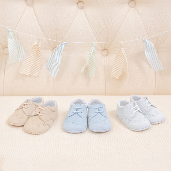 Flat lay photo of three pairs of Theodore Suede Shoes. Made from 100% suede with detailed edging. Available in colors blue, grey, and tan.