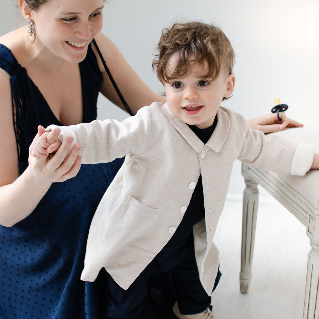 Baby boy with his mother wearing the tan Silas Trench Coat